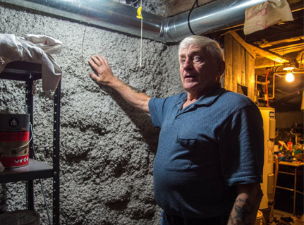 Robert Sperry describes the sprayform insulation added to the basement – the home is expected to be dramatically more energy efficient as a result of upgrades provided through the HomeWarming program.